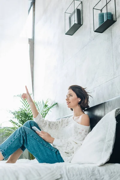 Low Angle View Brunette Woman Gesturing While Holding Smartphone Bed — Stock Photo, Image