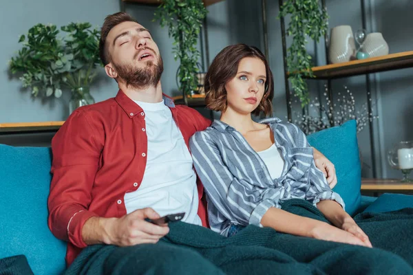 Tired Man Holding Remote Controller While Sleeping Sofa Woman Home — Stock Photo, Image