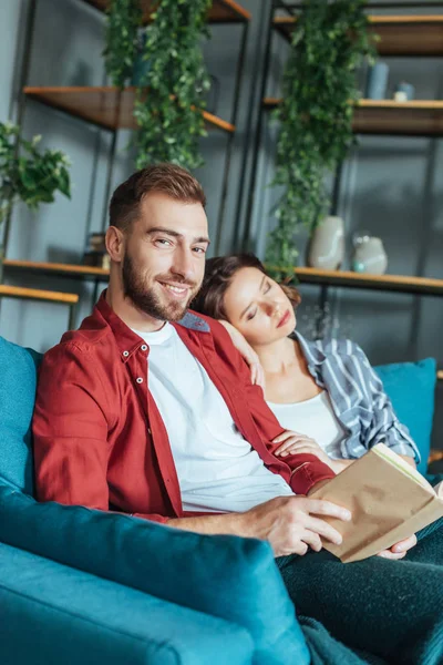 Selective Focus Handsome Man Looking Camera While Holding Book Sleeping — Stock Photo, Image