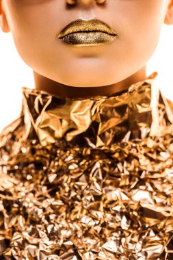 partial view of young woman with golden lips in golden foil isolated on white clipart