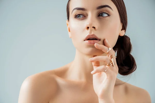 Young Naked Woman Shiny Makeup Golden Rings Touching Chin Looking — 스톡 사진