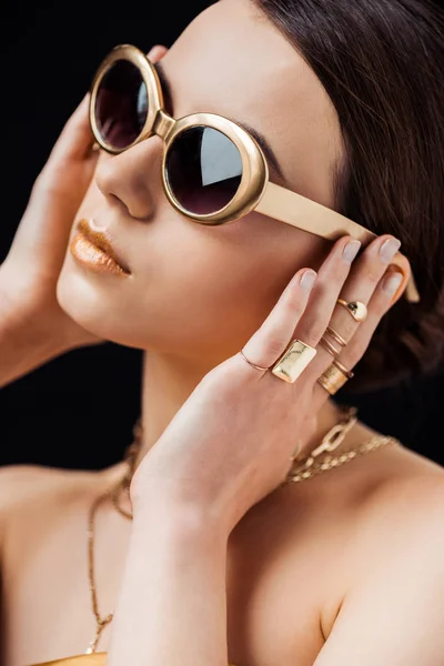 Young Woman Sunglasses Golden Rings Necklaces Touching Ears Isolated Black — Stock Photo, Image