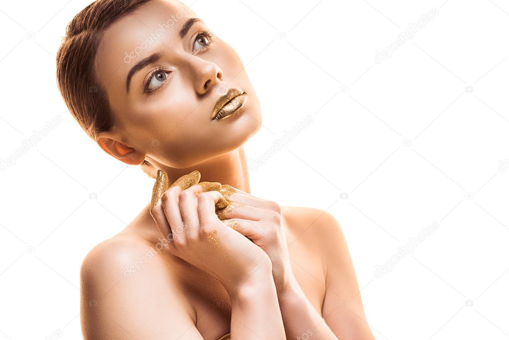 young naked woman with golden lips and fingers looking away isolated on white
