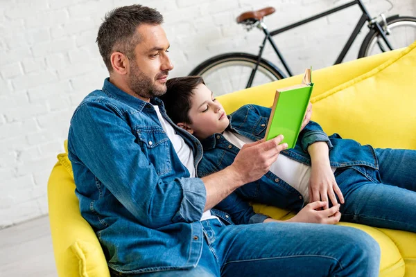 Father Son Denim Reading Book Couch Home — Stock Photo, Image