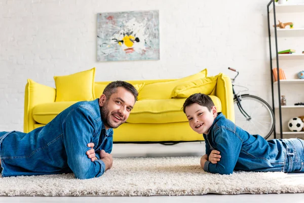Happy Father Son Denim Crossed Arms Lying Carpet Looking Camera — Stock Photo, Image
