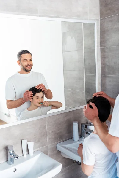 Smiling Father Adjusting Hairstyle Son Bathroom Morning — Stock Photo, Image