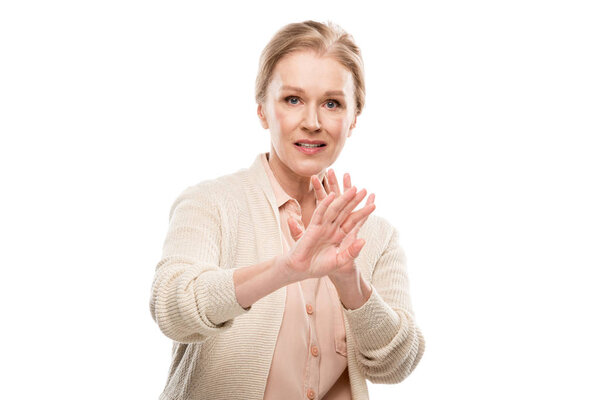 confused middle aged woman showing stop sign Isolated On White