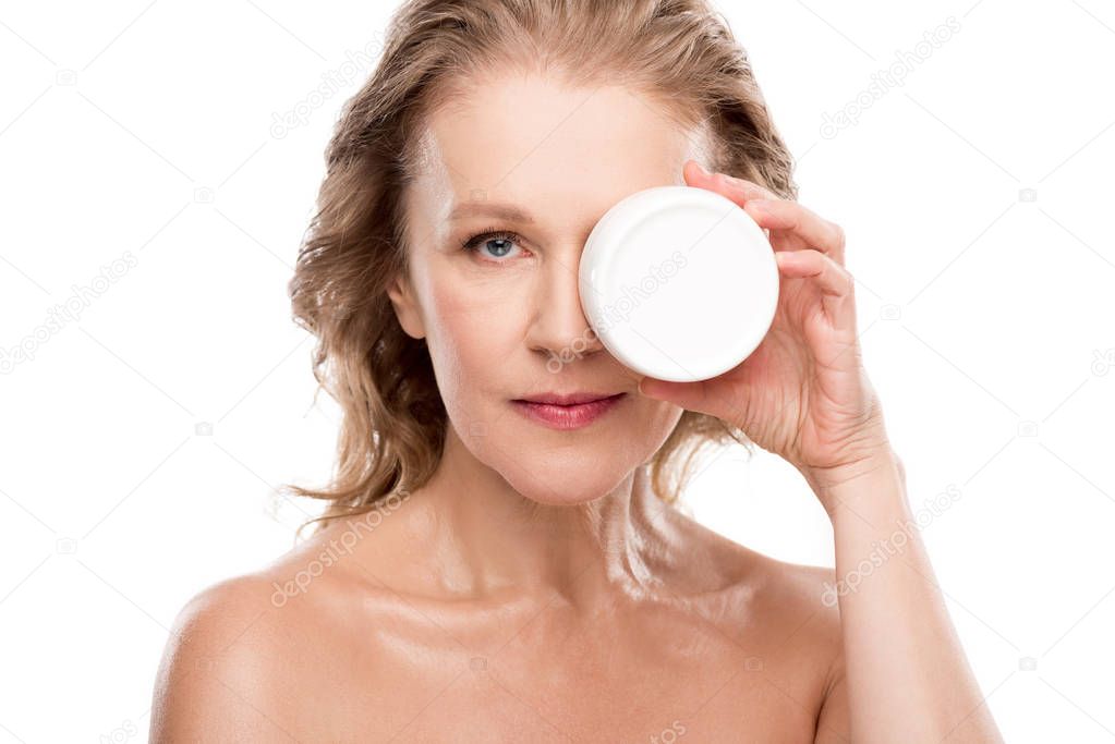 attractive mature woman holding container with cosmetic cream Isolated On White