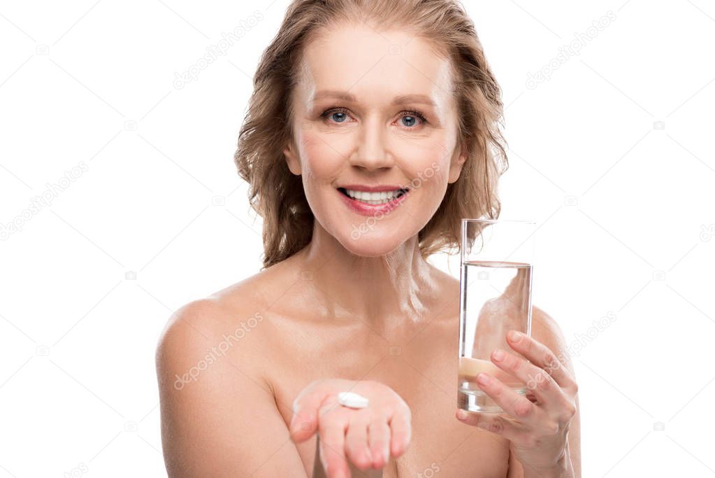 nude mature woman with glass of water and pills Isolated On White