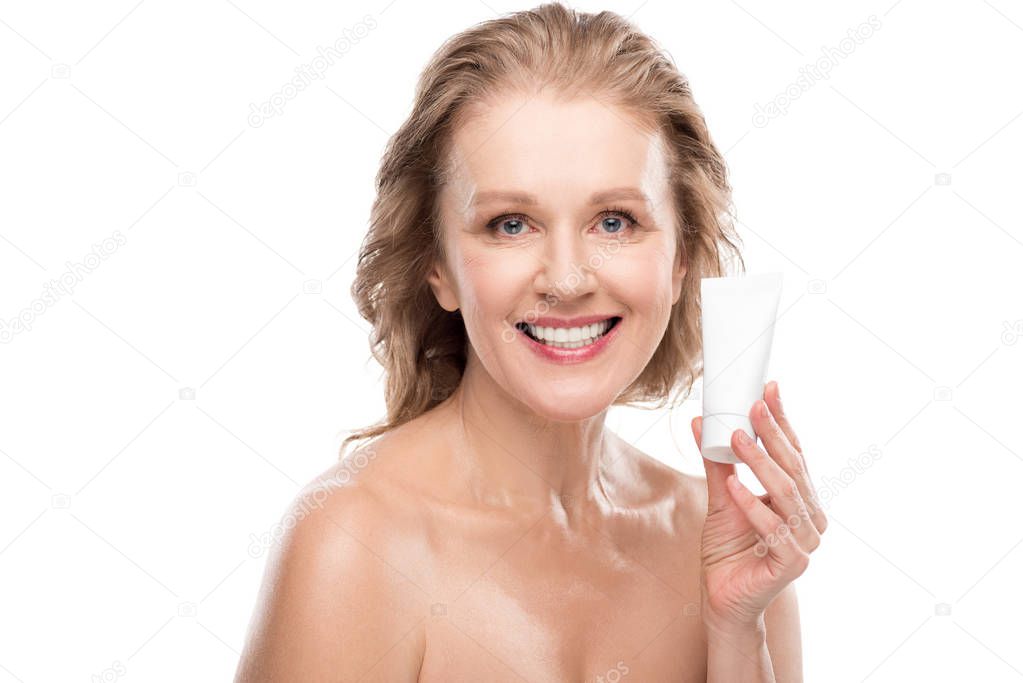beautiful smiling mature woman with perfect skin holding moisturizing Face cream Isolated On White