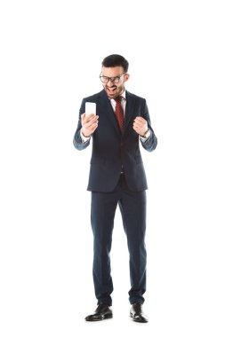 irritated businessman screaming and showing fist while having video call on smartphone isolated on white