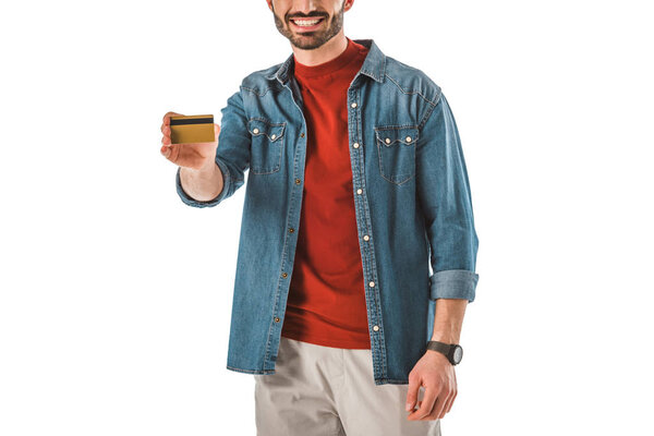 partial view of man in denim shirt holding credit card isolated on white