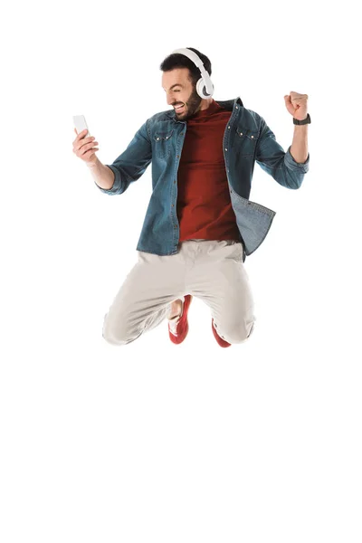 Izgatott Ember Fejhallgató Jumping Használata Közben Okostelefon Mutatja Igen Gesztus — Stock Fotó