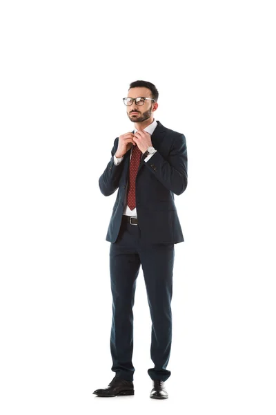 Serious Businessman Black Suit Touching Tie Looking Away Isolated White — Stock Photo, Image