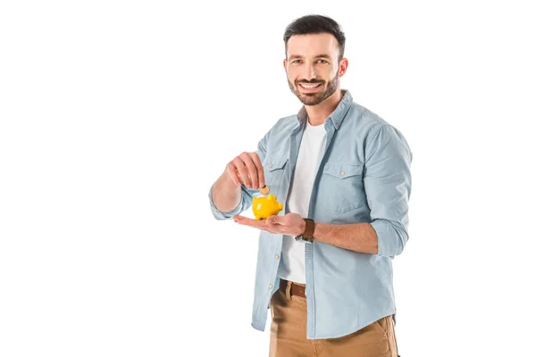 Cheerful Bearded Man Putting Coin Piggy Bank Looking Camera Isolated — Stock Photo, Image
