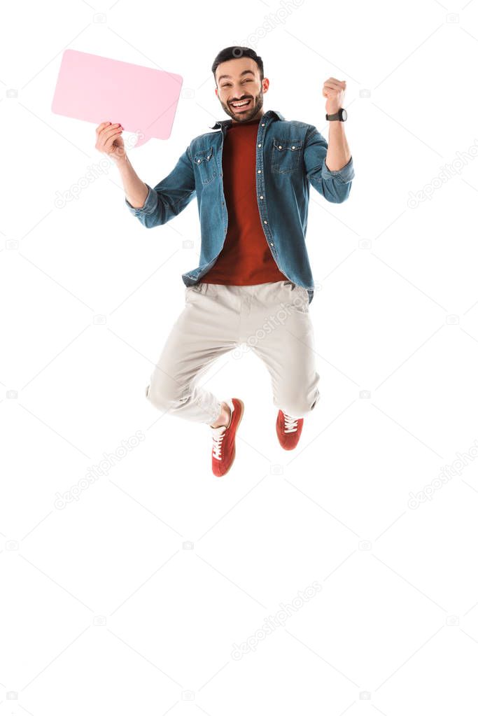 cheerful bearded man with speech bubble jumping and showing yes gesture isolated on white