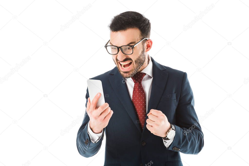 irritated businessman quarreling and showing fist while having video chat on smartphone isolated on white