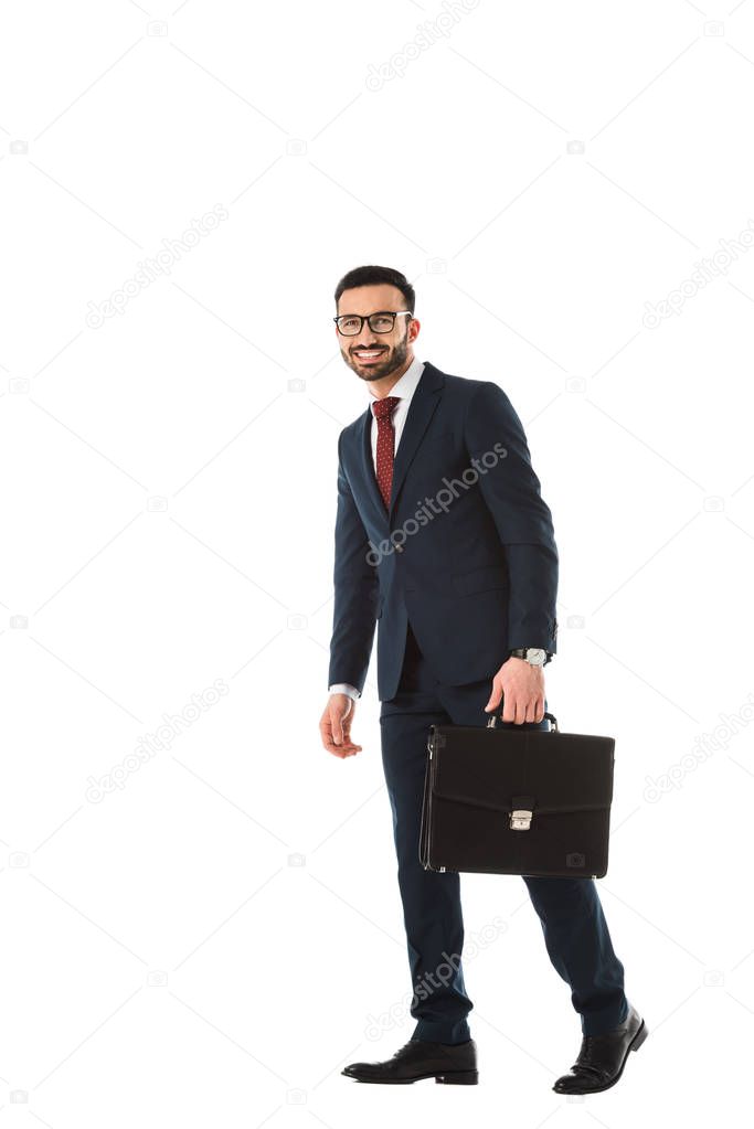 happy handsome businessman with briefcase smiling and looking at camera isolated on white