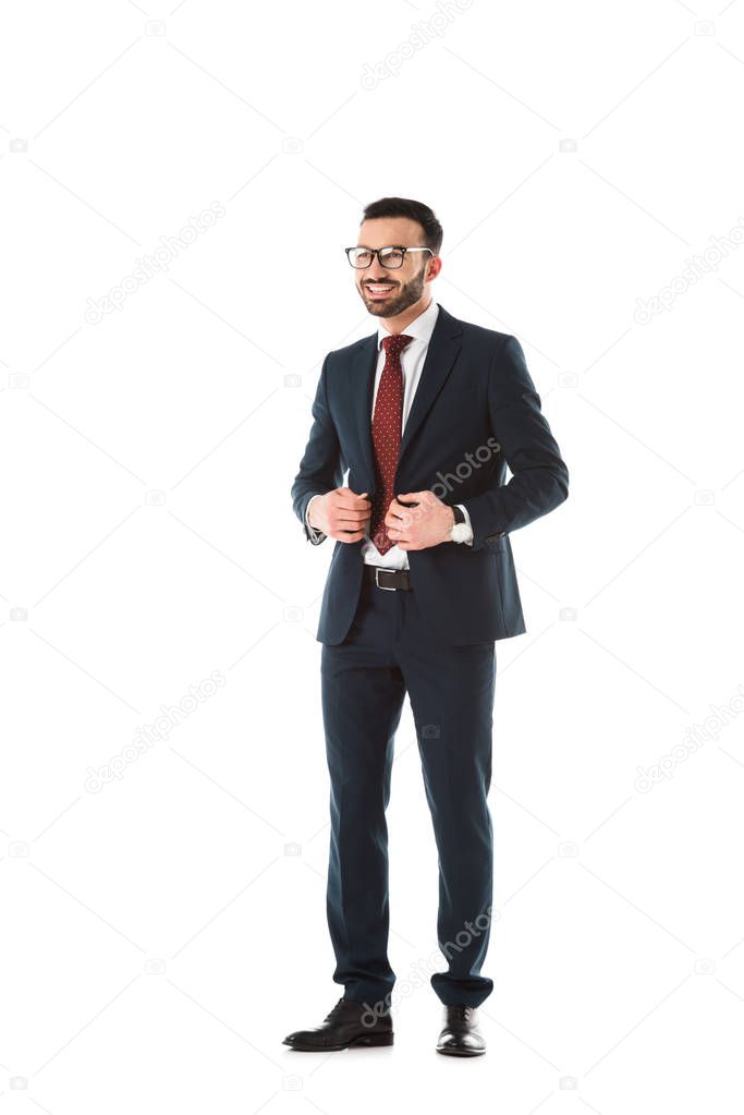 happy businessman in black suit smiling and looking away isolated on white