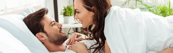 Panoramic Shot Happy Woman Looking Smiling Boyfriend While Lying Bedroom — Stock Photo, Image