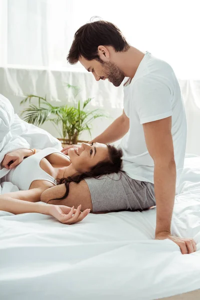 Happy Boyfriend Sitting Bed Looking Happy Girlfriend — Stock Photo, Image