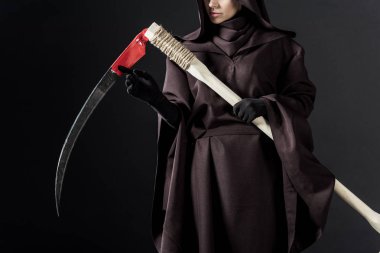 cropped view of woman in death costume holding scythe on black clipart
