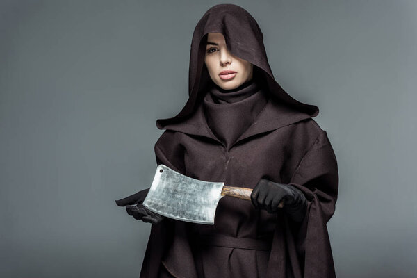 woman in death costume holding cleaver isolated on grey