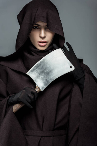 woman in death costume holding cleaver isolated on grey