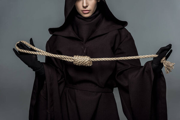 cropped view of woman in death costume holding hanging noose isolated on grey