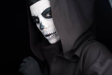 woman with skull makeup looking at camera isolated on black clipart