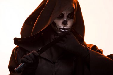 serious woman in death costume holding knife on white