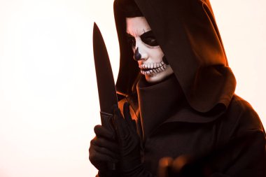 woman with skull makeup holding knife isolated on white clipart
