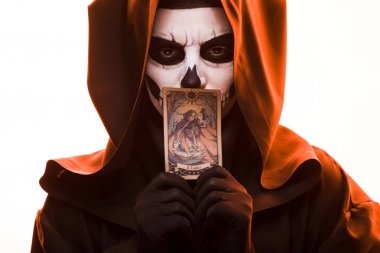 KYIV, UKRAINE - APRIL 18, 2019: woman with skull makeup holding tarot card isolated on white