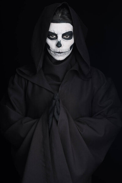 woman with skull makeup showing please gesture isolated on black