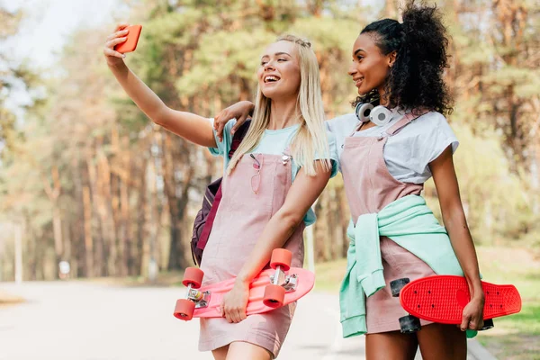 Two Smiling Multiethnic Friends Holding Penny Boards Taking Selfie Road — Stock Photo, Image