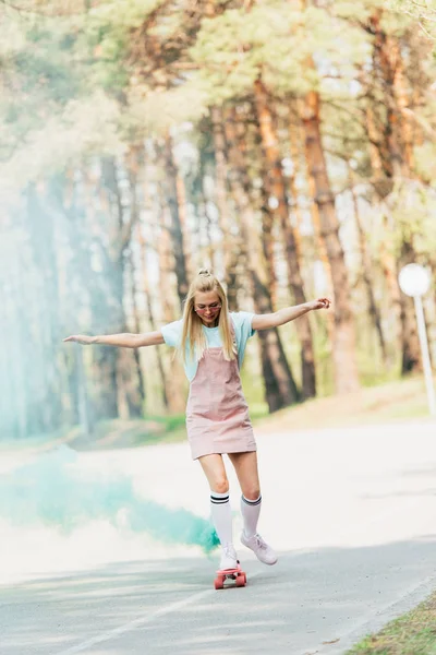 Blondes Mädchen Winkt Beim Skateboarden Grünen Rauch Auf Der Straße — Stockfoto