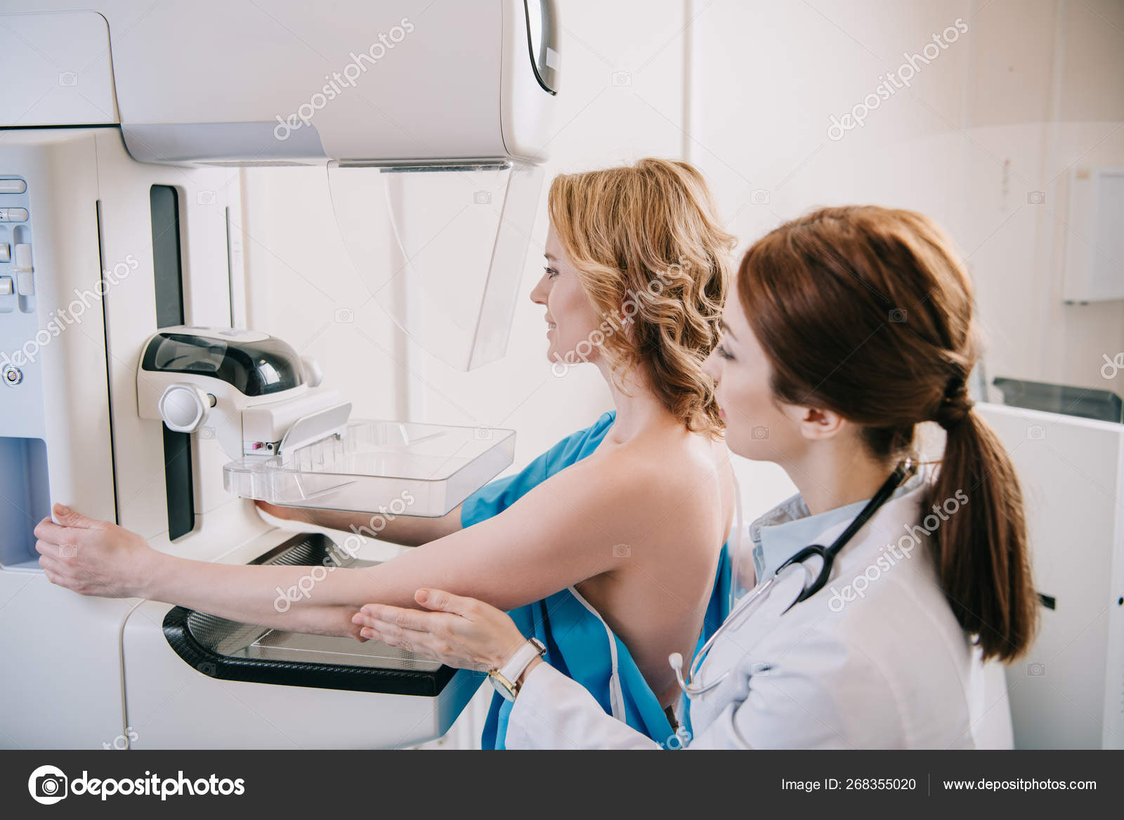 young-radiographer-standing-patient-while-making-mammography-test-ray-machine-stock-photo