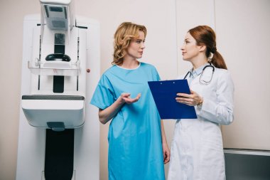 x-ray makinesi yakınında dururken radyolog ile konuşurken güzel kadın