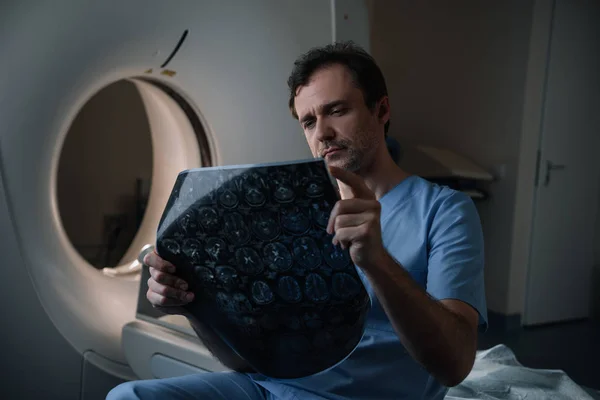 Attentive Doctor Looking Tomography Diagnosis While Sitting Scanner — Stock Photo, Image