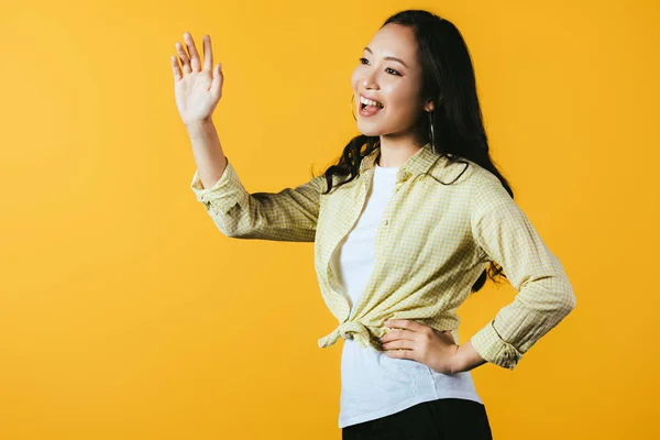Brunette Asian Girl Waving Isolated Yellow — Stock Photo, Image