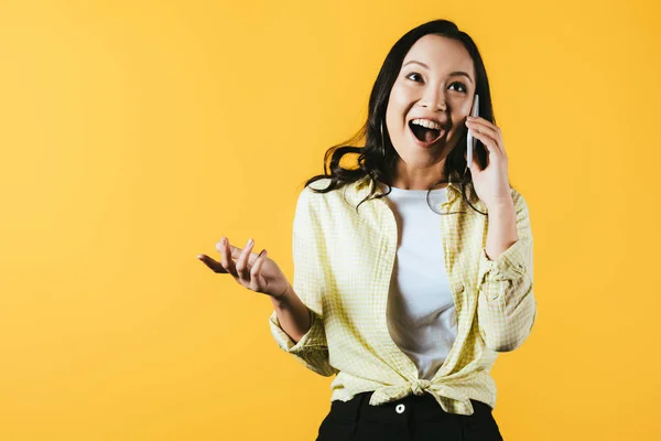 Excited Asian Girl Talking Smartphone Isolated Yellow — Stock Photo, Image