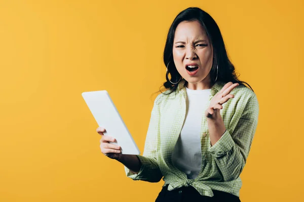 Aggressive Asian Girl Shouting Using Digital Tablet Isolated Yellow — Stock Photo, Image