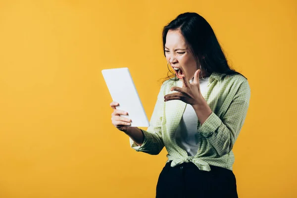 Angry Asian Girl Shouting Using Digital Tablet Isolated Yellow — Stock Photo, Image