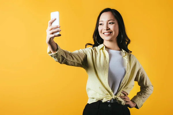 Smiling Asian Girl Taking Selfie Smartphone Isolated Yellow — Stock Photo, Image