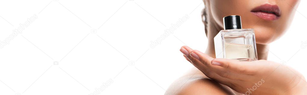 cropped view of woman holding perfume bottle, isolated on white