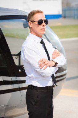 Helikopter yakın çapraz silah ile güneş gözlüğü ve resmi aşınma pilot