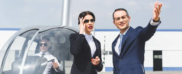 Panoramic Shot Businesspeople Suits Gesturing Helicopter Pilot — Stock Photo, Image