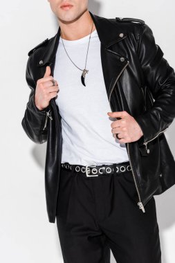 cropped view of stylish man touching leather jacket on white  clipart