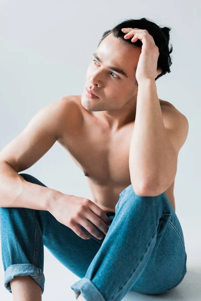 Pensive Shirtless Man Sitting Blue Jeans White — Stock Photo, Image