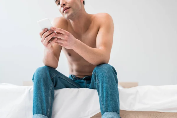 Low Angle View Man Holding Smartphone While Sitting Bed — Stock Photo, Image